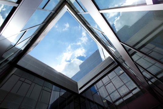 View from below through glass floors into the sky in the OIZ building in Zurich
