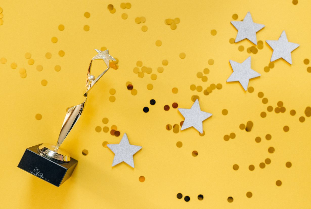 Cup with stars and confetti on a yellow background