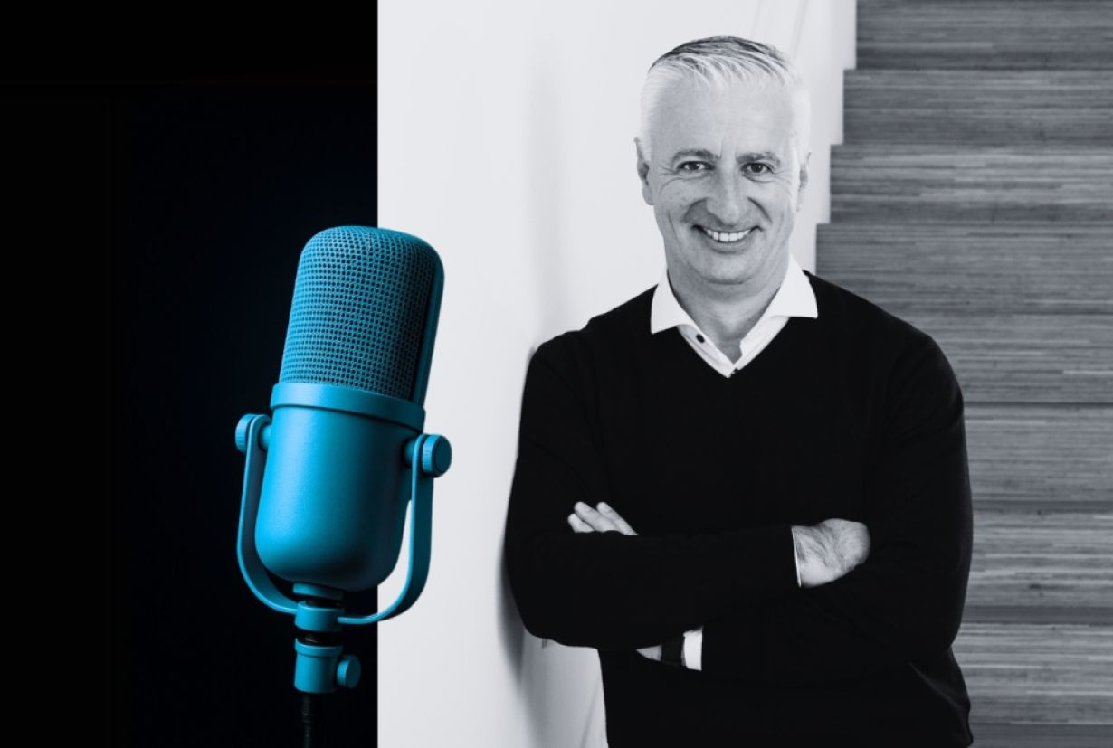 Porträtfoto von Olivier Rihs, Verwaltungsrat der Coopers Group, lächelnd mit verschränkten Armen neben einem Mikrofon.